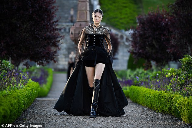 One model donned a stunning black gown, accentuated with a fanned-out skirt and corset-style bodice