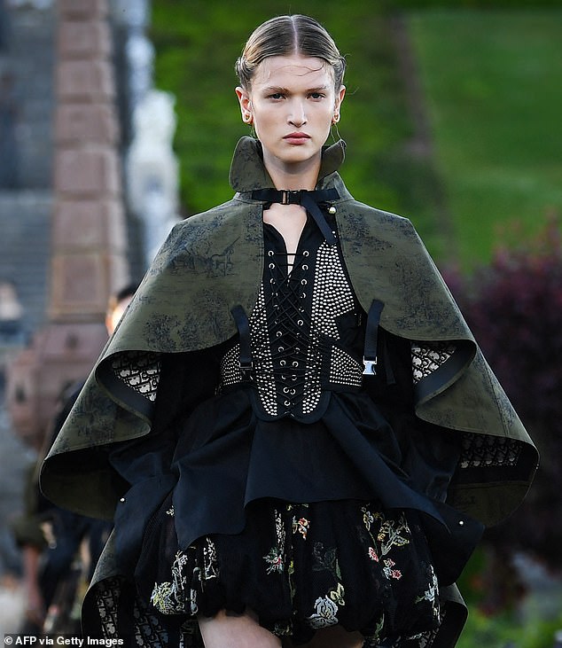 In yet another seeming nod to historic regal fashion, one model donned a cape over their dress