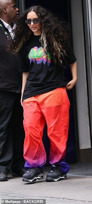 The Little Mix star also wore a pair of bright orange and purple trousers and added to her outfit with black trainers