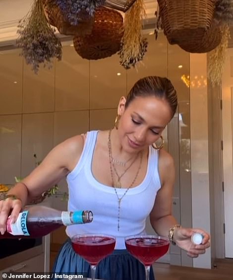 Charming kitchen: Earlier she was seen pouring the drink as baskets were overhead, also in October