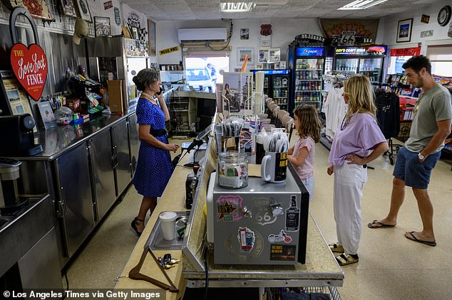 Assistant manager Nicole Rachel works behind the counter at Roy's as tourists stop in for snacks on May 24, 2024
