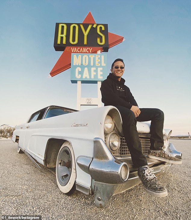 Okura poses in front of the classic Roy's sign sitting on the hood of Lincoln Continental