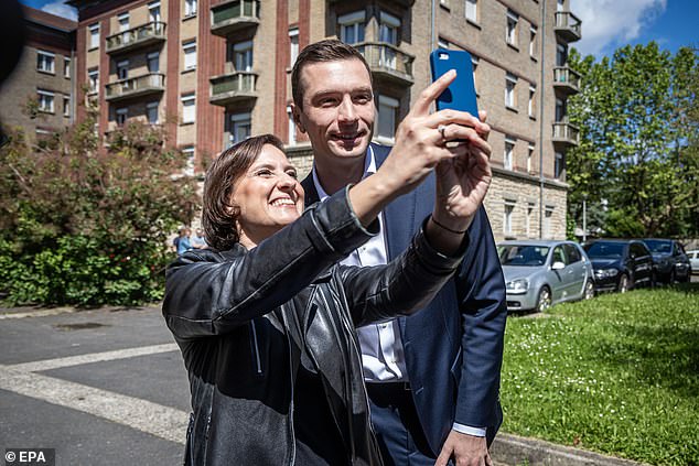 Bardella poses for a selfie with a supporter in Paris on Sunday