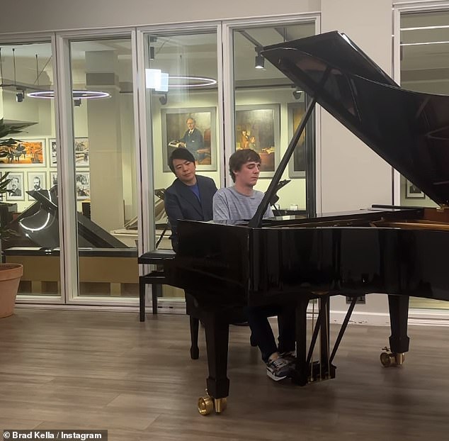 Brad pictured during his first ever piano lesson which was headed by Chinese superstar pianist Lang Lang