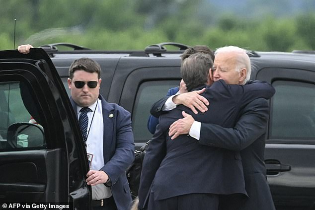 Hunter and Joe Biden hug on the tarmac at the Delaware Air National Guard Base in their first meeting after the federal gun trial guilty verdict