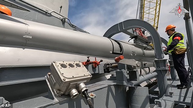 In this photo taken from video released by the Russian Defense Ministry Press Service on Wednesday, June 12, 2024, Russian military personnel load a cruise missile on board a warship during Russian military drills