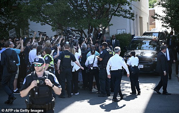 US Capitol police officers hold back media and protesters as former US President and Republican presidential candidate Donald Trump arrives at the House Republican Conference where he will meet with US House Republicans on Capitol Hill in Washington, DC, on June 13, 2024. (Photo by Brendan SMIALOWSKI / AFP) (Photo by BRENDAN SMIALOWSKI/AFP via Getty Images)