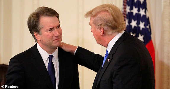 U.S. President Donald Trump speaks with Supreme Court nominee Judge Brett Kavanaugh in the East Room of the White House in Washington, U.S., July 9, 2018. REUTERS/Jim Bourg