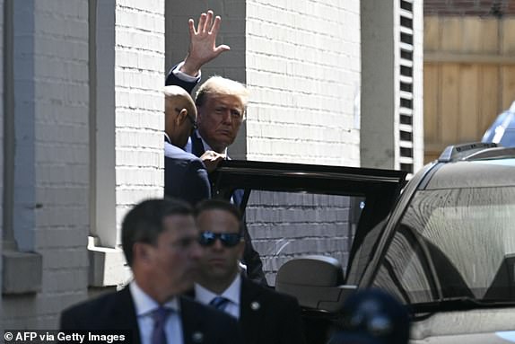 Former US President and Republican presidential candidate Donald Trump waves as he departs the Capitol Hill Club following a meeting with US House Republicans on Capitol Hill in Washington, DC, on June 13, 2024. (Photo by Brendan SMIALOWSKI / AFP) (Photo by BRENDAN SMIALOWSKI/AFP via Getty Images)