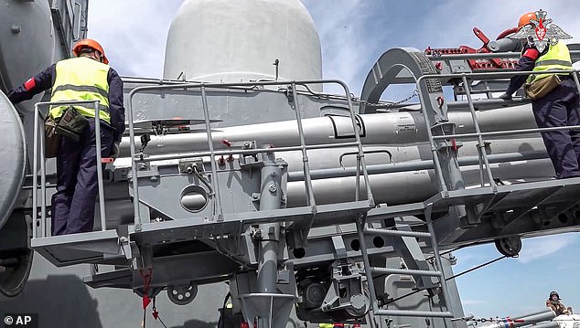 Missiles are loaded into launch tubes aboard a Russian warship