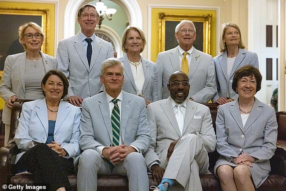 WASHINGTON, DC - JUNE 13: Sens. Maggie Hasan (D-NH), John Hickenlooper (D-CO), Tammy Baldwin (D-WI), Roger Wicker (R-MS), Lisa Murkowski (R-AK),  Amy Klobuchar (D-MN), Bill Cassidy (R-LA), Raphael Warnock (D-GA), and Susan Collins (R-ME), gather for the recognition of National Seersucker Day on Capitol Hill on June 13, 2024 in Washington, DC. Members of Congress wear seersucker clothing on Seersucker Thursday, an annual tradition that was initiated by former Senate Majority Leader Sen. Trent Lott (R-MS) in 1996, to mark the National Seersucker Day.  (Photo by Anna Rose Layden/Getty Images)