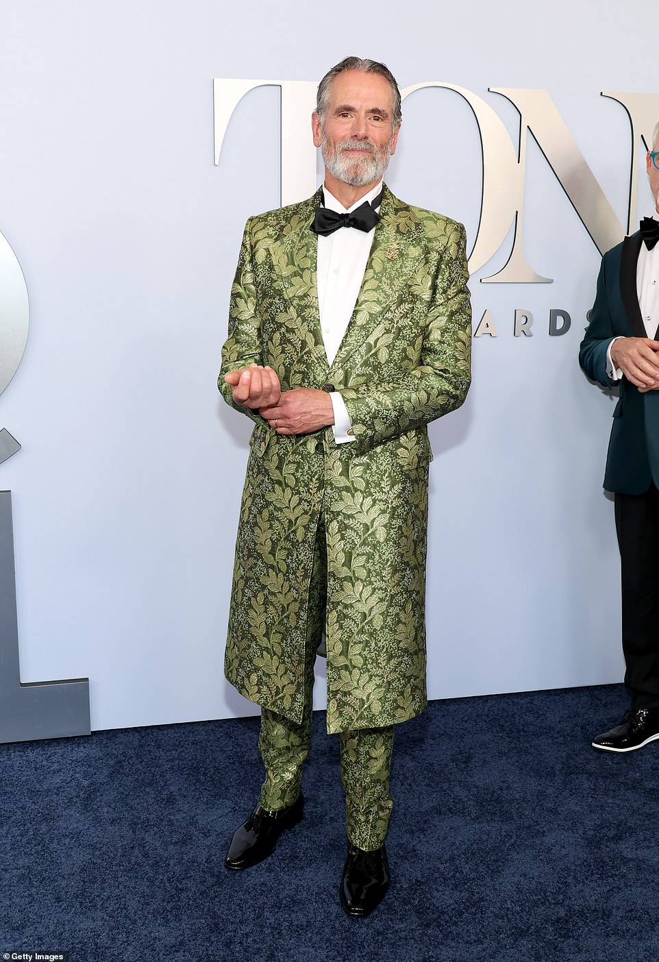 Actor Steven Skybell rocked a green knee-length blazer with matching trousers - both in a leaf pattern