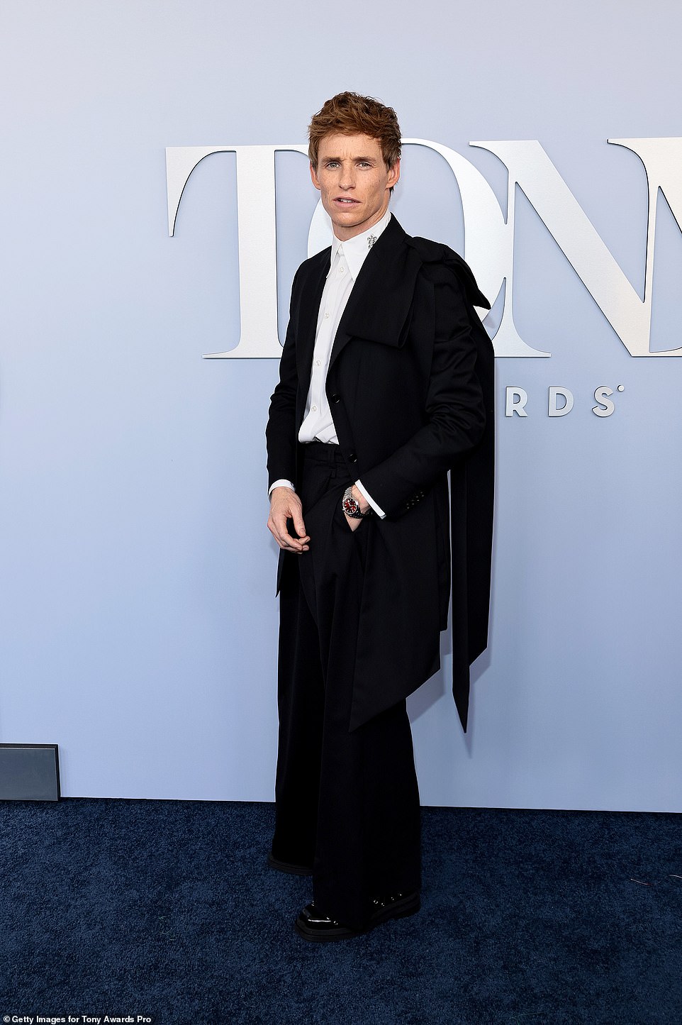 Eddie Redmayne chose a black and white look, complete with a cape