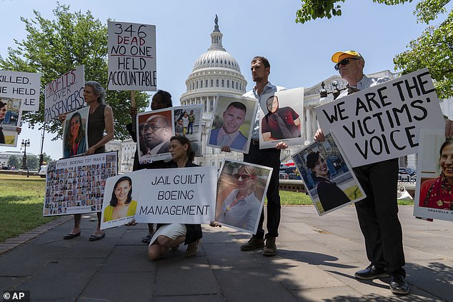 Family members of the crash victims of the Boeing 737 MAX8 in Ethiopia, hold photographs during a news conference on Capitol Hill on Tuesday