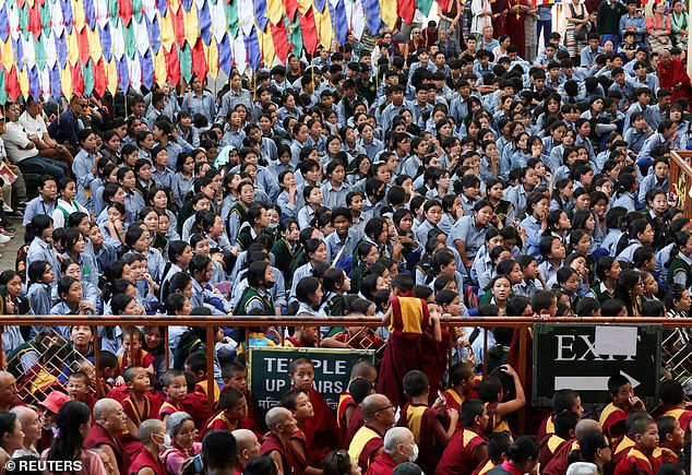 Tibetans gather outside the Dalai Lama's hillside home in Dharamshala, India, for the visit from U.S. lawmakers