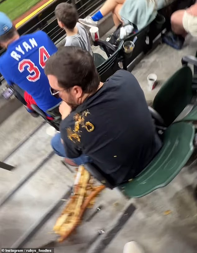 The hot dog first landed on an innocent spectator's shoulder during its descent to the ground