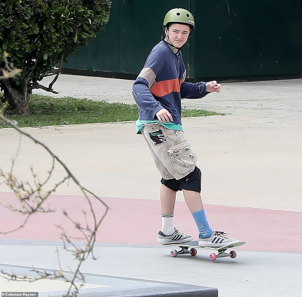 Ben Affleck's child, 15-year-old Fin (pictured), was spotted letting loose at the skatepark while wearing mix-matched socks and protective gear