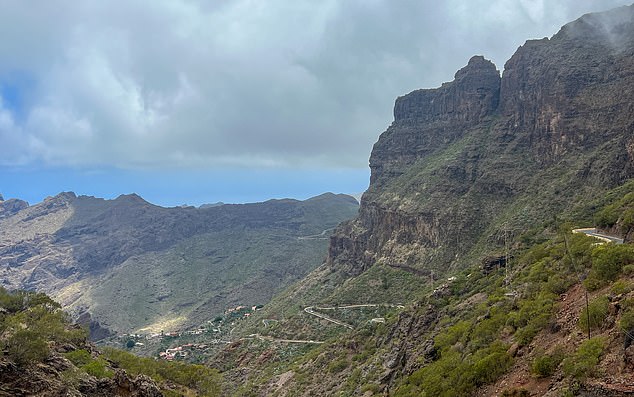 The setting is surrounded by spectacular mountains and rocky roads