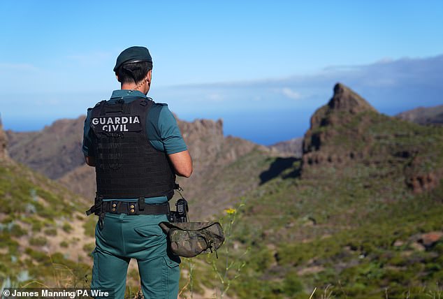 A police officer overlooks the village of Masca, Tenerife, as the search continues on June 21