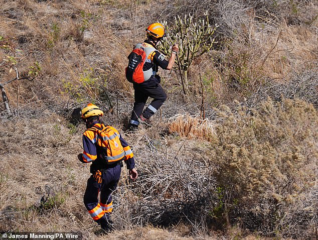 Emergency workers near the village of Masca, Tenerife as the search enters day five