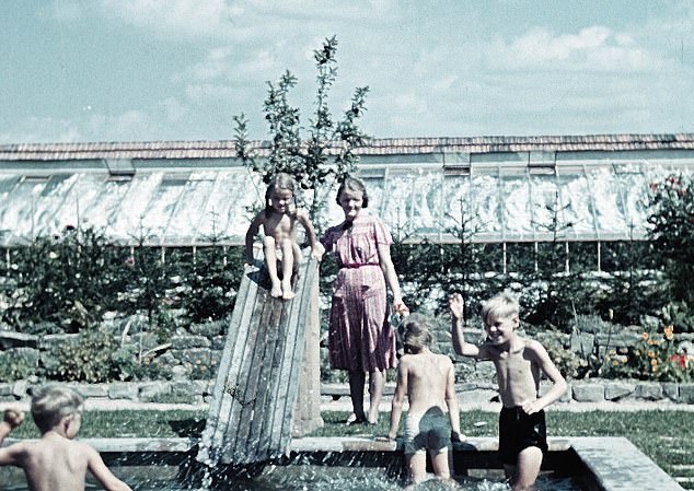 Rudolf Höss lived in a villa at the camp. In this photograph, his wife and four of their five children are seen playing in a paddling pool. Their idyllic family life is depicted in Martin Amis's novel 'The Zone of Interest' which was adapted into an Oscar-winning film by the same name