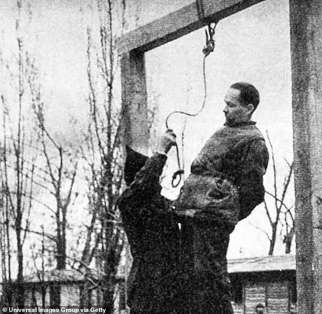 Rudolf Höss, commandant of the Auschwitz concentration camp, was hanged next to the Auschwitz crematorium in 1947 after being captured by Nazi hunters and tried for the part he played in the killing of more than one million people at the death camp. He is seen in this historic photograph moments before he was put to death