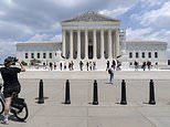 Visitors pose for photographs at the U.S. Supreme Court Tuesday, June 18, 2024, in Washington. ( AP Photo/Jose Luis Magana)