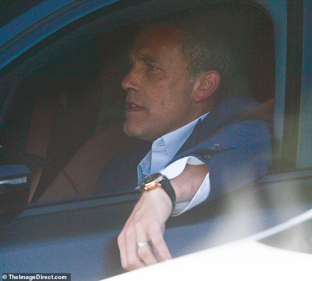 The 51-year-old actor - who previously ditched his wedding ring - looked all business in a suit while leaving his office in Los Angeles on Tuesday evening - before proudly flashing his gold band back on his ring finger