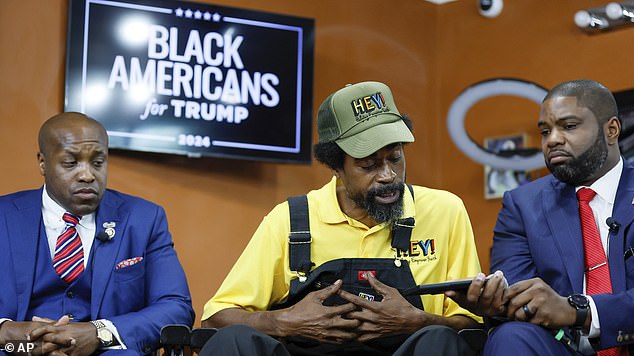 Nonprofit founder Marc KD Boyd (center) speaks with Donald Trump on speakerphone at a black business owners roundtable with Rep. Byron Donalds (right) and Rep. Wesley Hunt (left)
