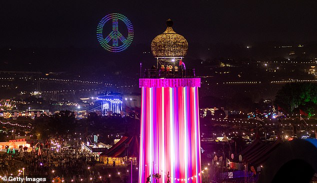 People watch a drone show at the end day one of Glastonbury Festival yesterday