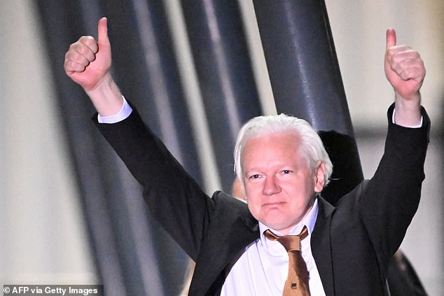 Assange gives a thumbs-up after arriving at Canberra Airport in Canberra on June 26, 2024