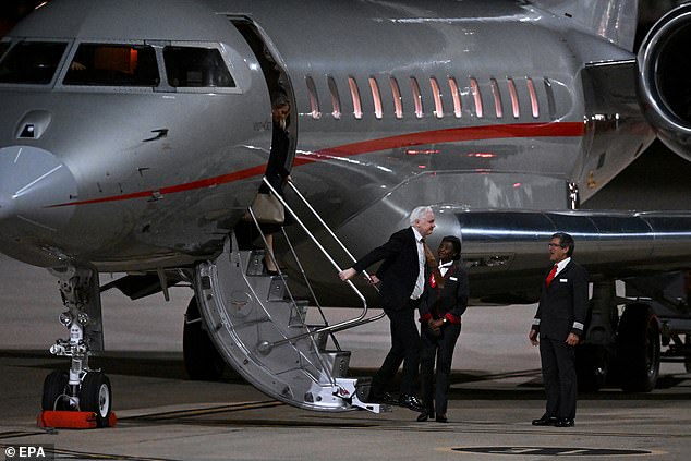 Assange (centre) steps onto Australian soil as he arrives at Canberra Airport on 26 June 2024