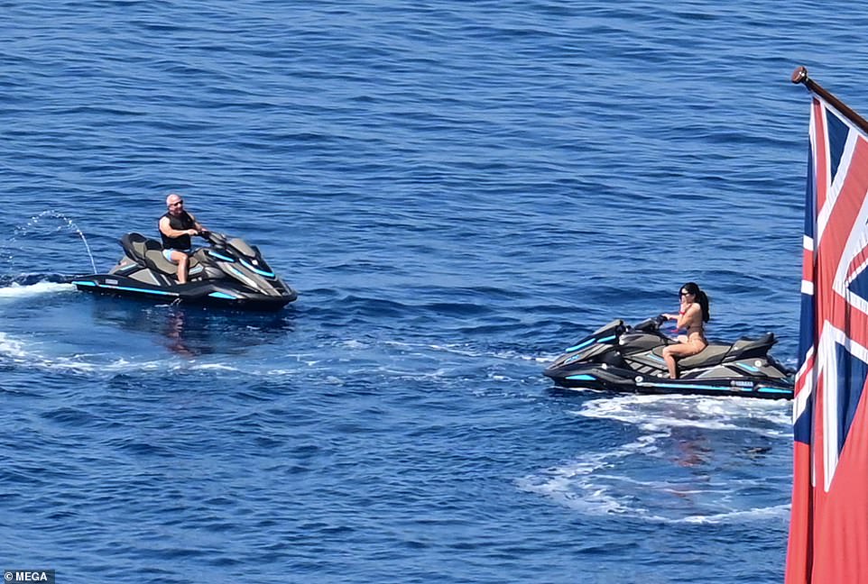 Lauren's husband-to-be, who sported a pair of tight blue swimming trunks,  joined her out on the shimmering blue waters of the Aegean Sea