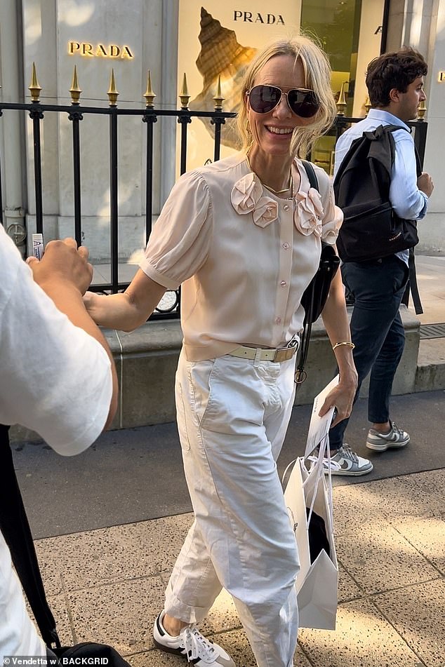Naomi Watts headed for a shopping spree in Prada on Friday, after coming under fire for attending Balenciaga's Paris Fashion Week show.