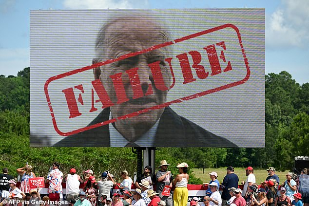 A poster of US President Joe Biden with the word 'Failure' stamped across his face is seen as people wait to hear Former US President and Republican presidential candidate Donald Trump