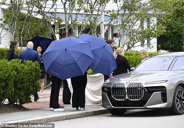 Others hoisted large white satin sheets above the sidewalk as a replica of the wedding dress train