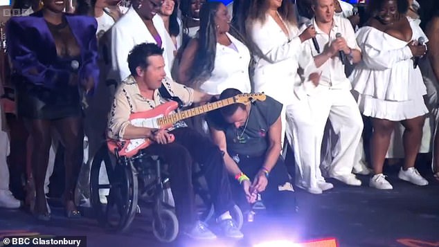 Glastonbury fans were left in tears when Michael J. Fox (L) made a surprise appearance on stage with Coldplay on Saturday (pictured with frontman Chris Martin)