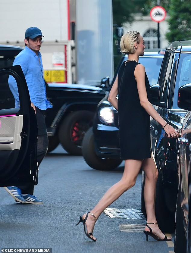 The model accessorised with a simple diamond necklace and slicked back her blonde locks in a wet look style