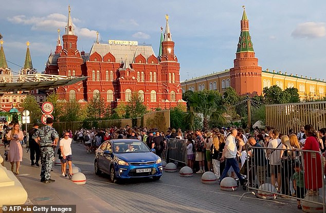 Fans wait for Kanye West at the Four Seasons Hotel in the centre of Moscow where it is thought the American rapper is staying