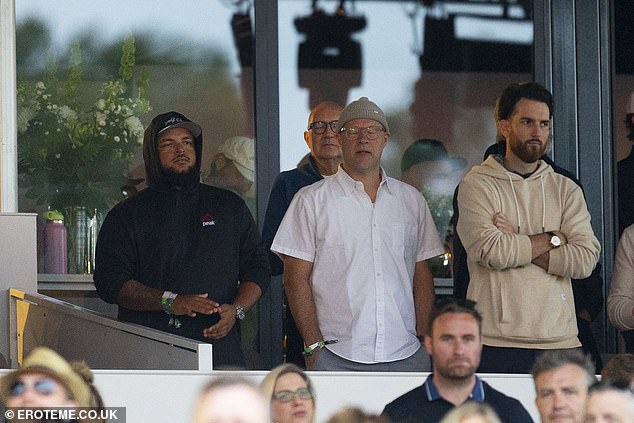 Connor, 29, kept a low profile as he watched the band perform, with his hood up, while with a small group of people in one of the VIP terrace areas