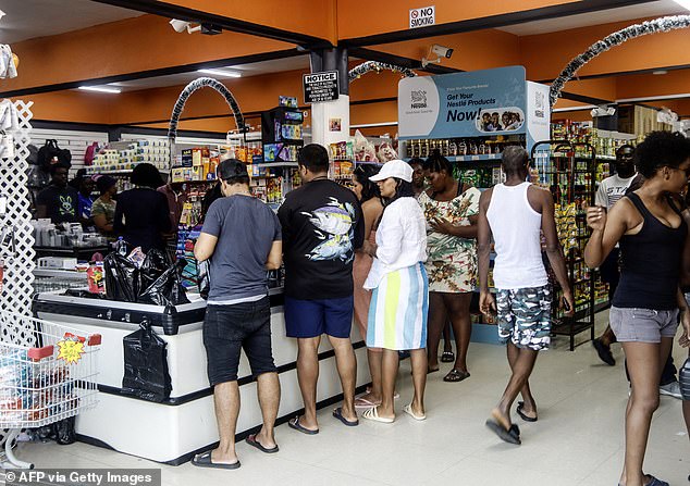 People shop groceries at a supermarket in Scarborough, Trinidad and Tobago, as they prepare for the arrival of Hurricane Beryl on June 30, 2024