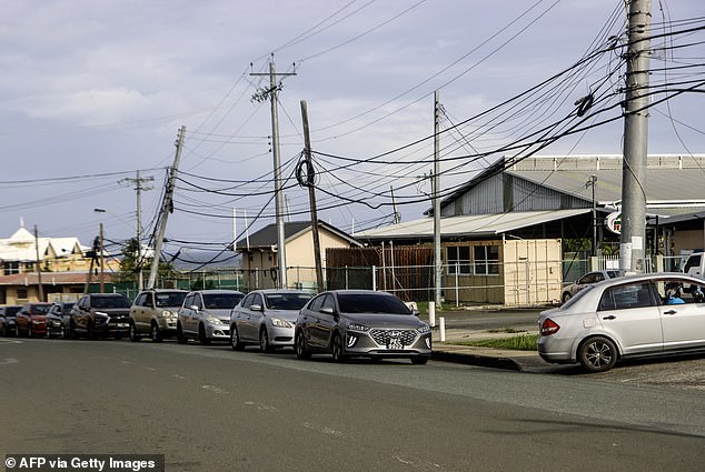 Drivers queue to fill their tanks outside a gas station in Scarborough, Trinidad and Tobago, as they prepare for the arrival of Hurricane Beryl on June 30, 2024