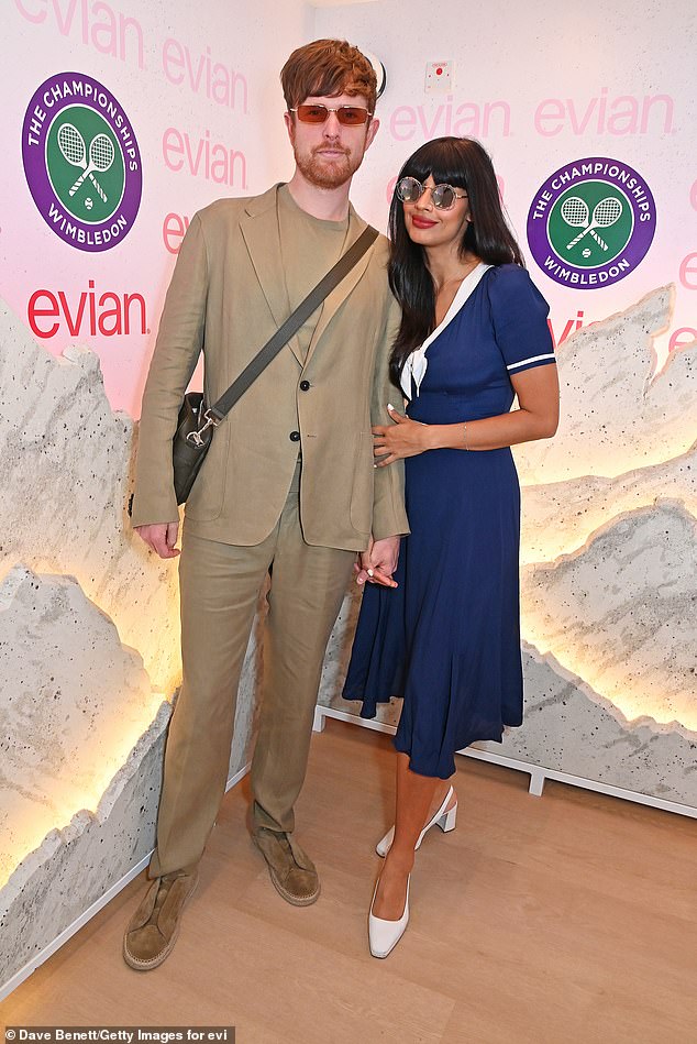 Enjoying the first day of the tennis tournament, Jameela looked stylish in a navy midi dress with a white trim bow V-neckline and a matching band around the waist