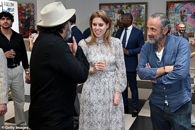 The princess appeared to be in high spirits as Mr Brainwash excitedly took her around the exhibit