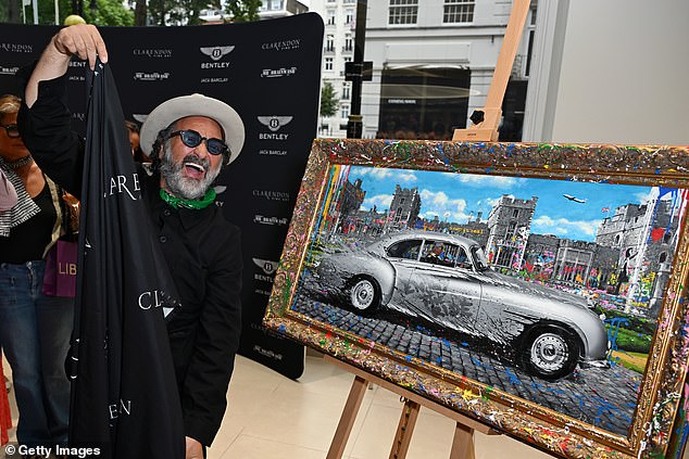 Mr Brainwash pictured attending the presentation of Mr. Brainwash by Clarendon Fine Art and Jack Barclay Bentley at Jack Barclay Bentley. Pictured, a painting of King Charles III behind a silver Bentley