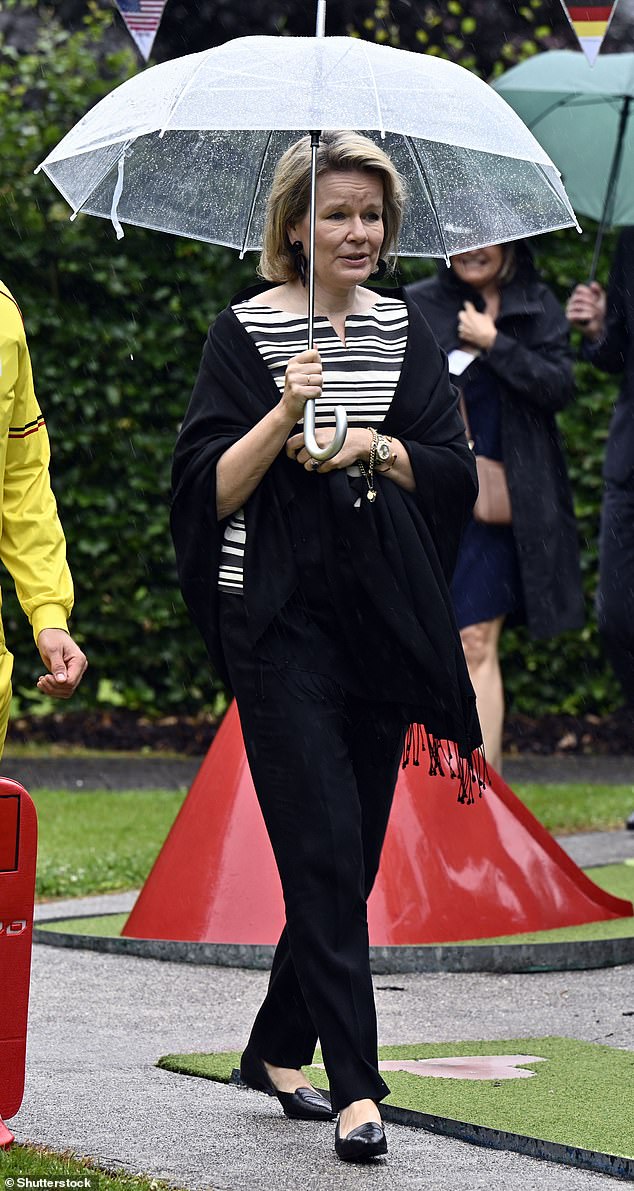 The-mother-of-four opted for a classic monochrome ensemble as she stepped out in the rainy Belgium city