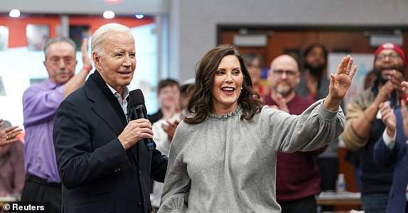 U.S. President Joe Biden speaks next to Michigan Governor Gretchen Whitmer, as he meets with autoworkers after the United Auto Workers (UAW) union recently endorsed Biden's reelection bid, at the UAW Region 1 George Merrelli Technical Training Center in Warren, in the Detroit metro area, Michigan, U.S., February 1, 2024. REUTERS/Kevin Lamarque