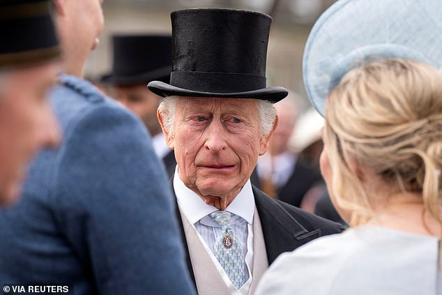 Charles pictured enjoying a conversation during the Sovereign's Garden Party held at the Palace of Holyroodhouse in Edinburgh