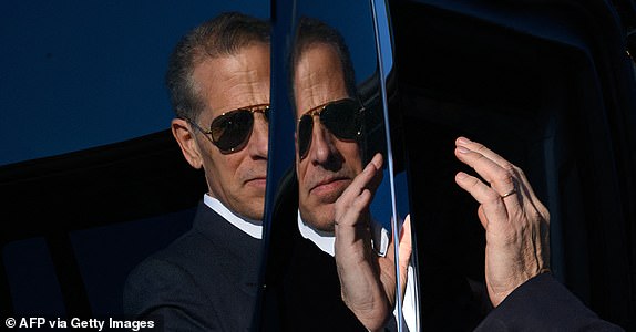 A reflection on the side of a vehicle shows Hunter Biden, son of US President Joe Biden, stepping into a car upon arrival at Fort Lesley J. McNair in Washington, DC, on July 1, 2024. Hunter Biden was traveling with his father who returned to Washington for the first time after the first presidential debate in Atlanta on June 27. (Photo by Mandel NGAN / AFP) (Photo by MANDEL NGAN/AFP via Getty Images)