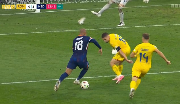 Romania keeper Florian Nita (top of photo) was forced to kick one trainer away as Malen shot